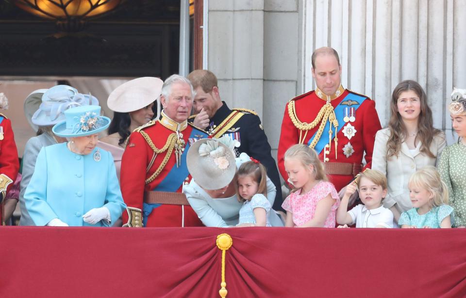 Prince Harry shares a joke with Meghan Markle on the balcony at Buckingham Palace.