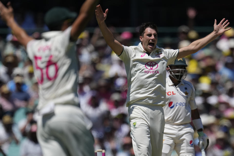 Australia's Pat Cummins, center, appeals for a LBW decision on Pakistan's Babar Azam, right, who is given out on review during their cricket test match in Sydney, Wednesday, Jan. 3, 2024. (AP Photo/Rick Rycroft)