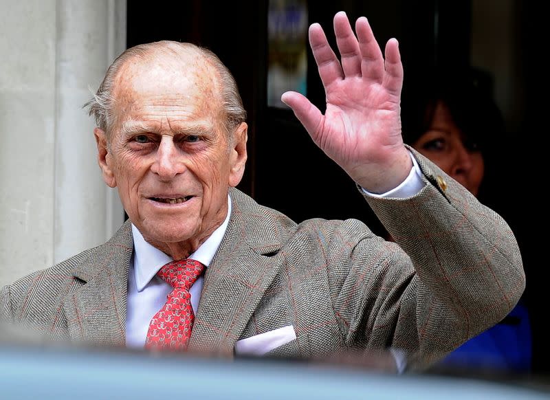 FILE PHOTO: Britain's Prince Philip waves to members of the media as he leaves the King Edward VII Hospital in London