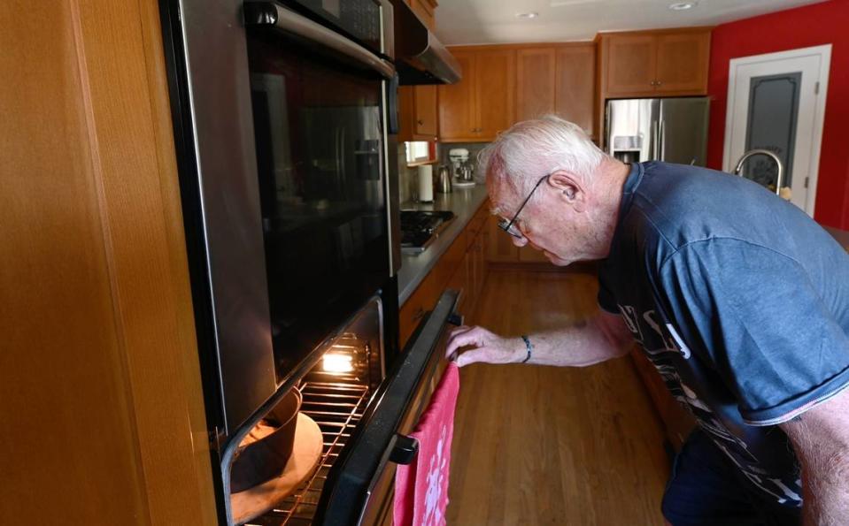 Melvin “Gabe” Gabelhaus, 98, checks the progress of his baking. Photographed in Modesto, Calif., Saturday, August 26, 2023.