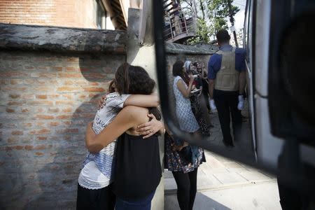 Israeli survivors from the blizzard hug each other, as they get ready to board a bus to the airport to head back to their country in Kathmandu October 18, 2014. REUTERS/Navesh Chitrakar