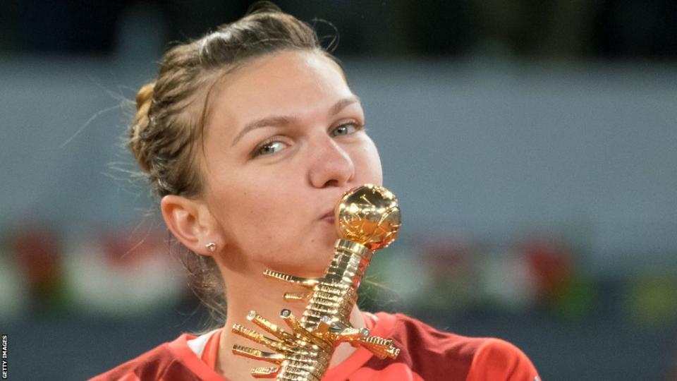 Simona Halep kisses the Madrid Open trophy