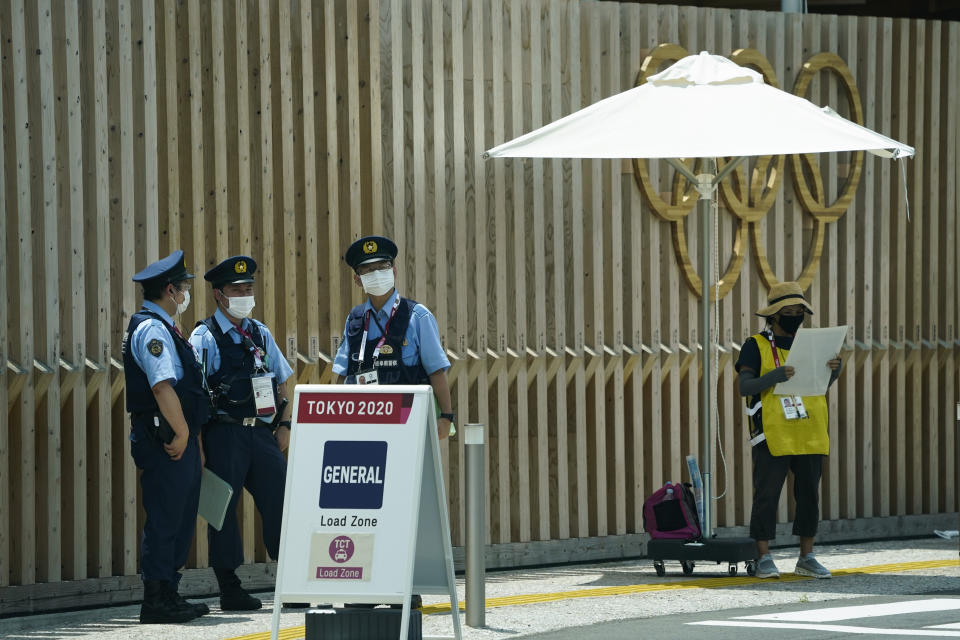 Police officers stand near the entrance to the athlete's village for the 2020 Summer Olympics and Paralympics, Thursday, July 15, 2021, in Tokyo. The pandemic-delayed games open on July 23 without spectators at most venues. (AP Photo/Jae C. Hong)