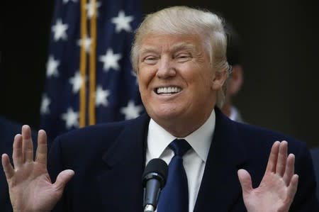 Republican U.S. presidential candidate Donald Trump smiles while speaking to the media during a news conference at the construction site of the Trump International Hotel at the Old Post Office Building in Washington, March 21, 2016. REUTERS/Jim Bourg