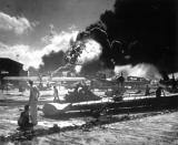 <p>In this image provided by the U.S. Navy, sailors stand among wrecked airplanes at Ford Island Naval Air Station as they watch the explosion of the USS Shaw in the background, during the Japanese surprise attack on Pearl Harbor, Hawaii, on December 7, 1941. (AP Photo/U.S. Navy) </p>