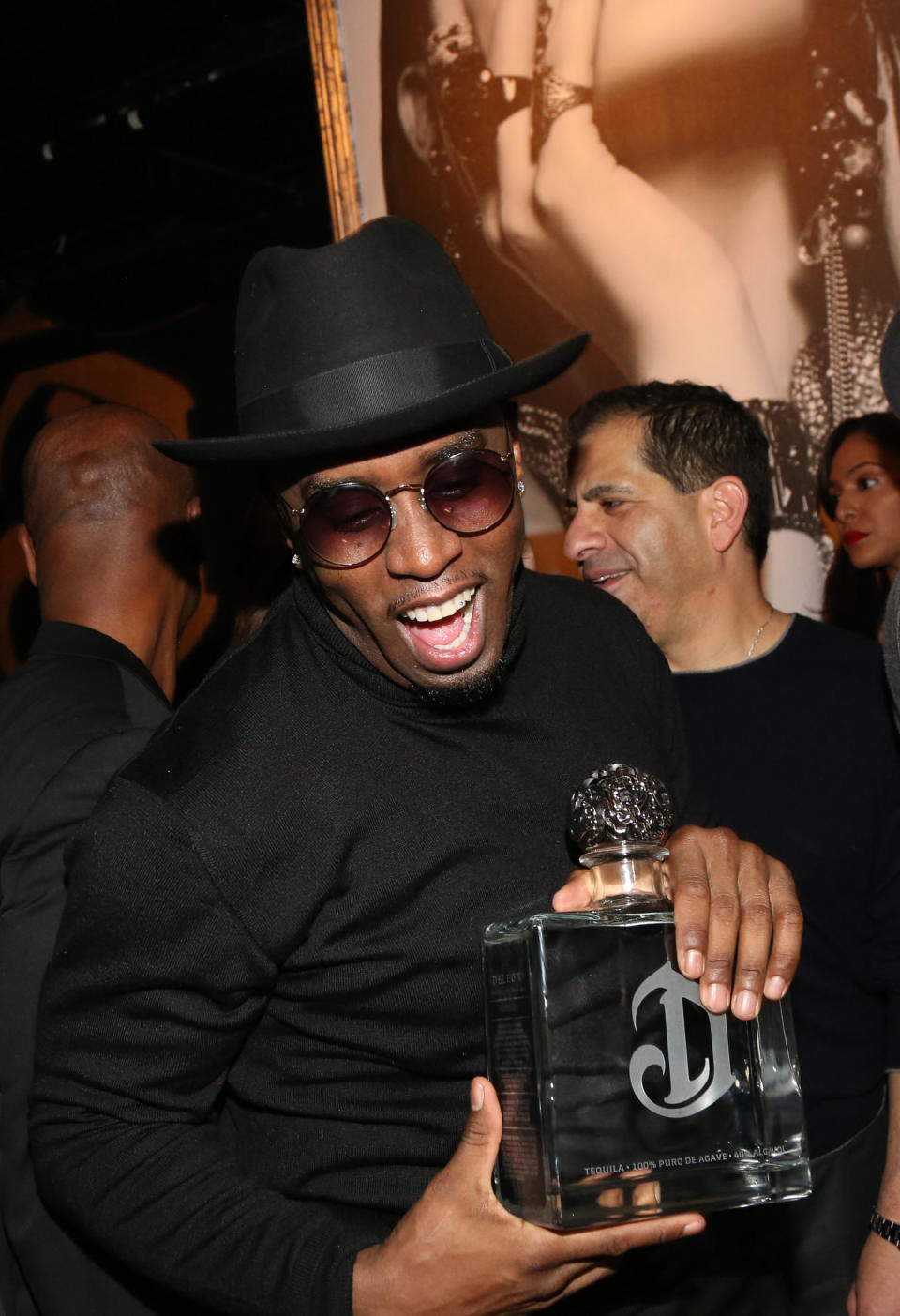 Combs holds a bottle as he attends a DeLeón tequila launch party in 2014.