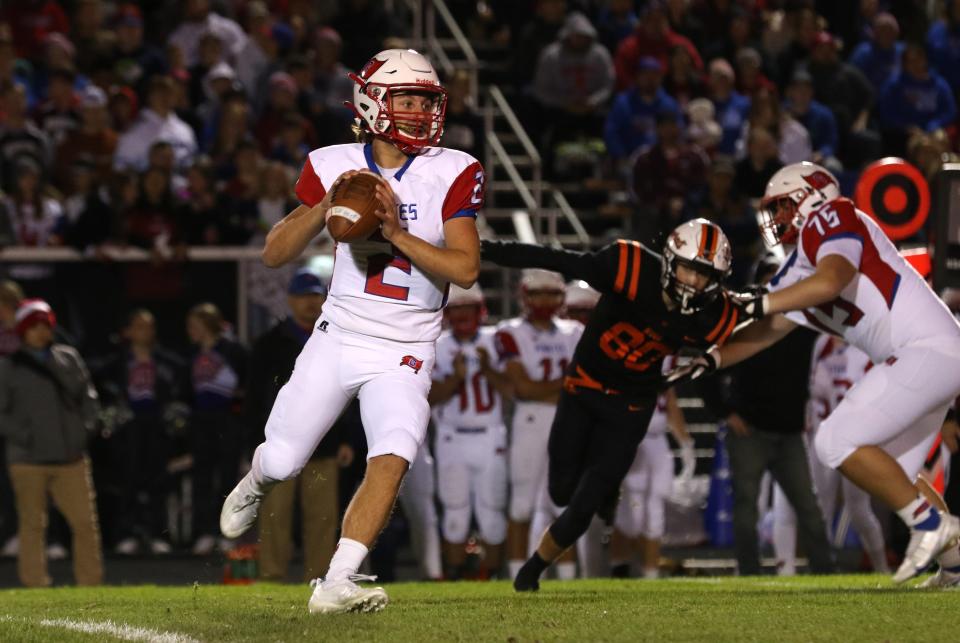 Garaway's Logan Yoder rolls out of the pocket against Ridgewood.