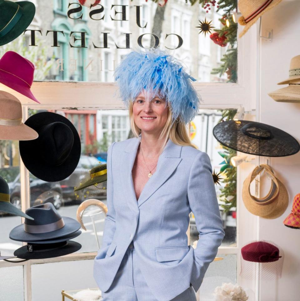 Jess Collett models a hat in her studio