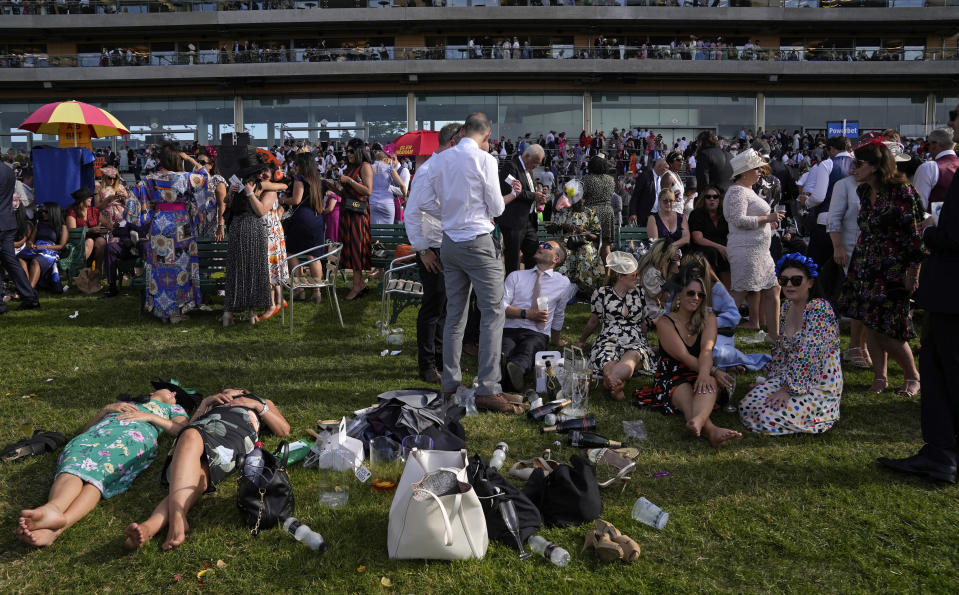 Racegoers take in the atmosphere on the third day of the Royal Ascot horserace meeting, at Ascot Racecourse, in Ascot, England, Thursday, June 16, 2022. The third day is traditionally known as Ladies Day. (AP Photo/Alastair Grant)