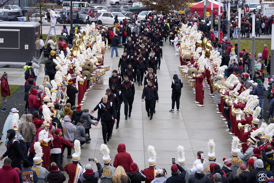 Iowa State players arrive for an NCAA college football game against West Virgina, Saturday, Nov. 5, 2022, in Ames, Iowa. College athletic programs of all sizes are reacting to inflation the same way as everyone else. They're looking for ways to save. Travel and food are the primary areas with increased costs. (AP Photo/Charlie Neibergall)