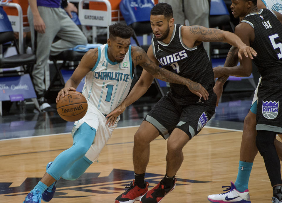 Charlotte Hornets guard Malik Monk (1) drives to the hoop past Sacramento Kings guard Cory Joseph (9) during the second half of an NBA basketball game in Sacramento, Calif., Sunday, Feb. 28, 2021. The Hornets won 127-126. (AP Photo/Randall Benton)