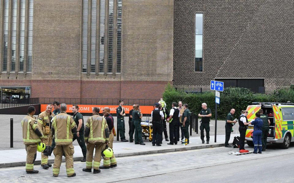 Police, ambulance crews and fire crews are seen outside the Tate Modern gallery in London after it was placed on lockdown   - AFP