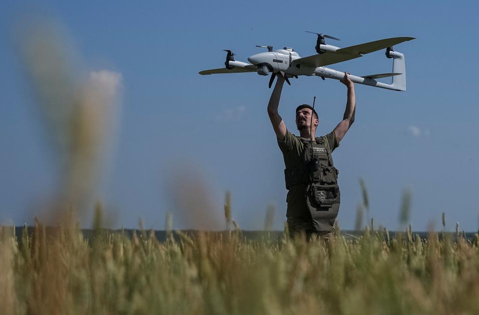 A Ukrainian soldier launches a mid-range reconnaissance drone for flying over Russian troop positions (REUTERS)