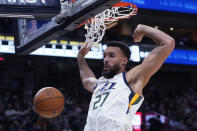 FILE - Utah Jazz center Rudy Gobert dunks against the Houston Rockets during the second half of an NBA basketball game on Feb. 14, 2022, in Salt Lake City. Gobert has been traded by the Jazz to the Minnesota Timberwolves for a massive package of players and draft picks, a person with knowledge of the blockbuster deal said. Utah is getting four first-round picks between 2023 and 2029, along with Patrick Beverley, Malik Beasley and a first-round pick this year in Walker Kessler, according to the person who spoke to The Associated Press on Friday, July 1, 2022, on condition of anonymity because the NBA had not approved the deal and neither team could announce it publicly. (AP Photo/Rick Bowmer, File)