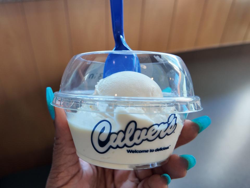 hand holding up a scoop of vanilla custard from culvers