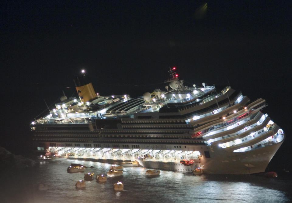 FILE - In this file photo taken Friday, Jan. 13, 2012, the luxury cruise ship Costa Concordia lays on its starboard side after it ran aground off the coast of the Isola del Giglio island, Italy. As if the nightmares, flashbacks and anxiety weren't enough, passengers who survived the terrifying grounding and capsizing of the Costa Concordia off Tuscany have come in for a rude shock as they mark the first anniversary of the disaster on Sunday, Jan. 13, 2013. Ship owner Costa Crociere SpA, the Italian unit of Miami-based Carnival Corp., sent several passengers a letter telling them they weren't welcome at the official anniversary ceremonies on the island of Giglio where the hulking ship still rests. Costa says the day is focused on the families of the 32 people who died Jan. 13, 2012, not the 4,200 passengers and crew who survived. (AP Photo/Giuseppe Modesti, File)