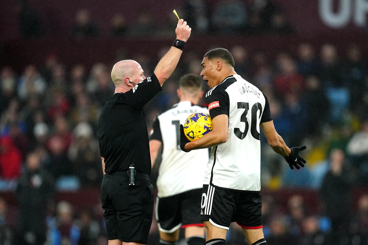 Fulham's Carlos Vinicius (right) reacts after being shown a yellow card by referee Simon Hooper for dissent during the Premier League match at Villa Park, Birmingham. Picture date: Sunday November 12, 2023. (Photo by Nick Potts/PA Images via Getty Images)