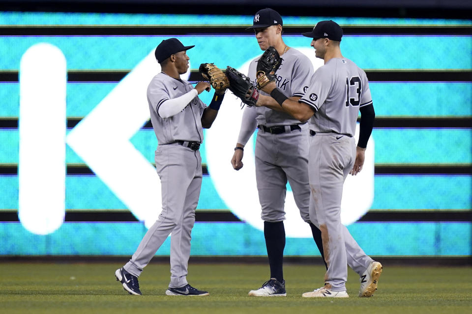 New York Yankees left fielder Greg Allen, left, center fielder Aaron Judge, center, and right fielder Joey Gallo celebrate after the team's 3-1 win in a baseball game against the Miami Marlins, Friday, July 30, 2021, in Miami. (AP Photo/Lynne Sladky)