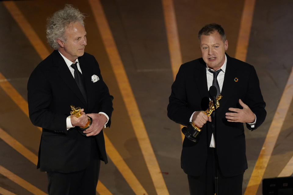 Charlie Mackesy, left, and Matthew Freud accept the award for best animated short for "The Boy, the Mole, the Fox and the Horse" at the Oscars on Sunday, March 12, 2023, at the Dolby Theatre in Los Angeles. (AP Photo/Chris Pizzello)