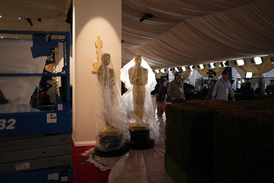 Plastic covers Oscars statues along the red carpet ahead of the 96th Academy Awards Friday, March 8, 2024, in Los Angeles. (AP Photo/John Locher)