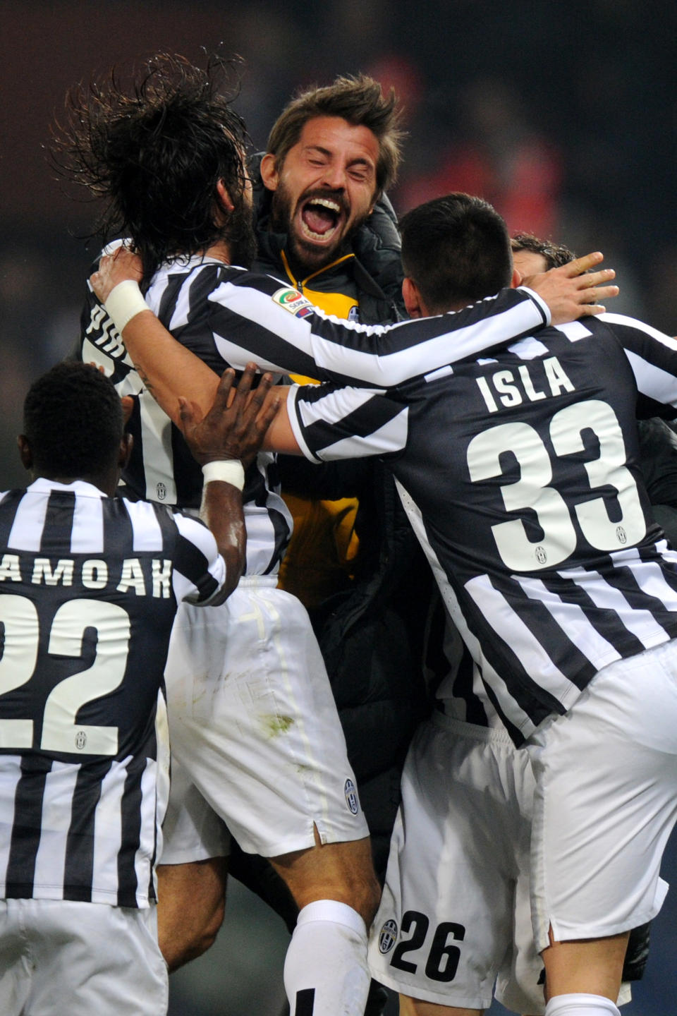 Juventus' Andrea Pirlo, second left, celebrates with teammates after scoring during a Serie A soccer match between Genoa and Juventus, at Genoa's Luigi Ferraris Stadium, Italy, Sunday, March 16, 2014. A late Andrea Pirlo goal saw Juventus maintain its charge to a third successive Serie A title as it beat Genoa 1-0 on Sunday to extend its lead to 17 points. Pirlo fired home a stunning free kick two minutes from time as Juventus struggled to a victory after Gianluigi Buffon had saved Emanuele Calaio's penalty for Genoa. (AP Photo/Tano Pecoraro)