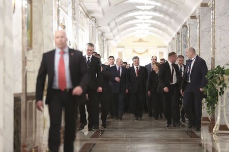 Belarus' President Alexander Lukashenko (L, 1st row), Ukraine's President Petro Poroshenko (C, 1st row) and Germany's Chancellor Angela Merkel (R, 1st row) walk as they take part in peace talks on resolving the Ukrainian crisis in Minsk, February 11, 2015. REUTERS/Mykhailo Palinchak/Ukrainian Presidential Press Service/Handout via Reuters