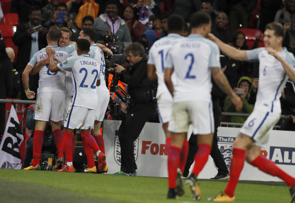 England’s Harry Kane, 2nd left, celebrates after scoring the opening goal during the World Cup Group F qualifying soccer match between England and Slovenia at Wembley stadium in London, Thursday, Oct. 5, 2017. (AP Photo/Kirsty Wigglesworth)