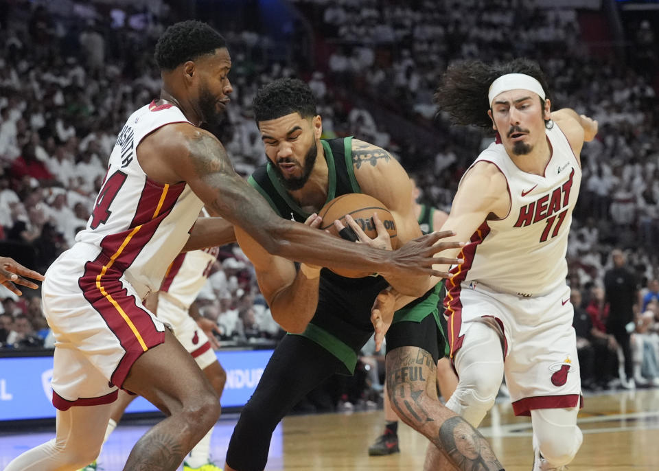 Miami Heat forward Haywood Highsmith (24) and guard Jaime Jaquez Jr. (11) defend Boston Celtics forward Jayson Tatum during the first half of Game 4 of an NBA basketball first-round playoff series, Monday, April 29, 2024, in Miami. (AP Photo/Marta Lavandier)