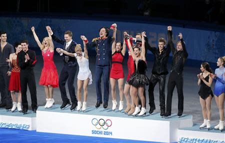 The Russian figure skating team (C) celebrates on the podium at the Sochi 2014 Winter Olympics, February 9, 2014. REUTERS/David Gray