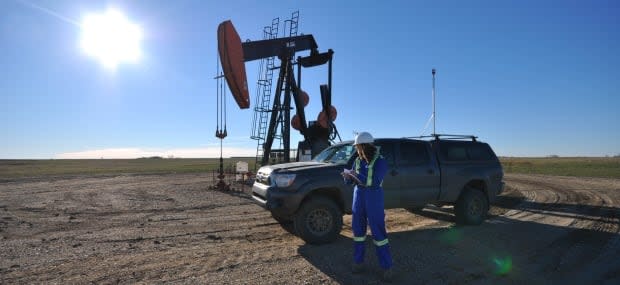 A FluxLab researcher in the field conducting methane measurements at an oil and gas site. The team uses instruments on trucks and drives to thousands of sites.