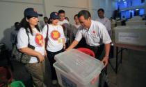 Association of South East Asian Nations (ASEAN) election observers check a polling station in Yangon on April 1, 2012. In an attempt by the government burnish its reform credentials, foreign observers and journalists have been invited to witness the vote