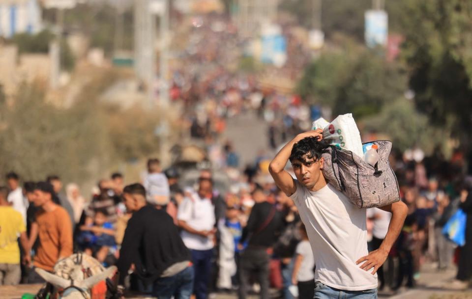 A Palestinian man carries his belongings on 9 November (AFP via Getty Images)