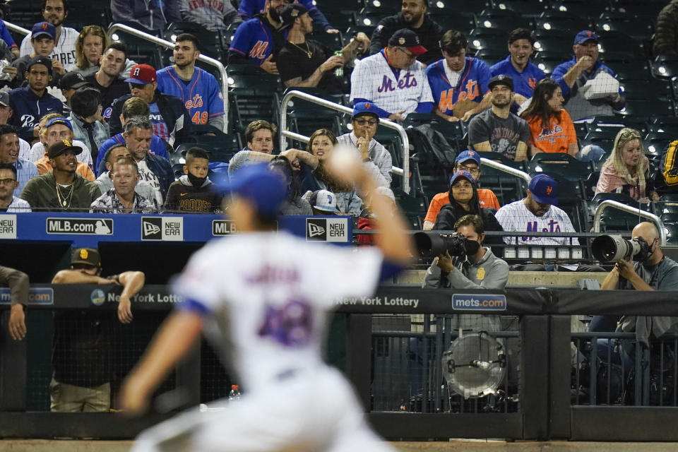 Fans watch as New York Mets' Jacob deGrom (48) delivers a pitch during the fifth inning of a baseball game against the San Diego Padres, Friday, June 11, 2021, in New York. (AP Photo/Frank Franklin II)