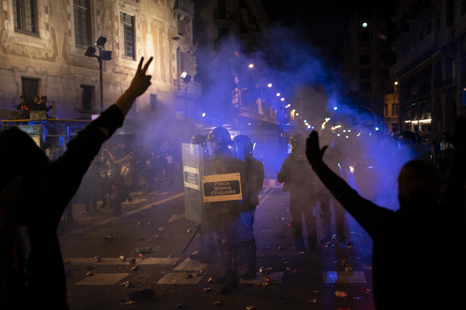 Police take position during clashes with protesters in Barcelona, Saturday, Oct. 26, 2019. The clash comes after 350,000 people protested peacefully Saturday against the imprisonment of nine Catalan separatist leaders for their roles in an illegal 2017 secession bid. (AP Photo/Felipe Dana)