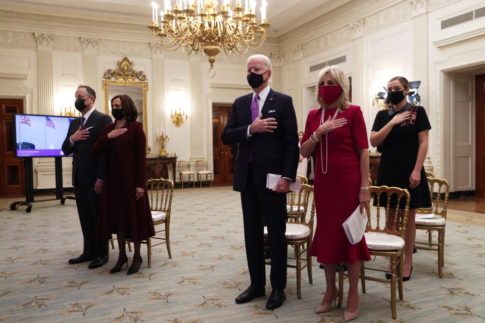 President Joe Biden, first lady Jill Biden, Vice President Kamala Harris and second gentleman Doug Emhoff listen to the national anthem as they watch the virtual presidential inaugural prayer service in the State Dining Room of the White House Jan. 21, 2021.