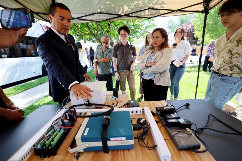 Daniel Mendoza, of the University of Utah, explains one of their air quality monitors to U.S. Environmental Protection Agency regional administrator for Region 8 KC Becker during an event at NeighborWorks in Salt Lake City on Tuesday.