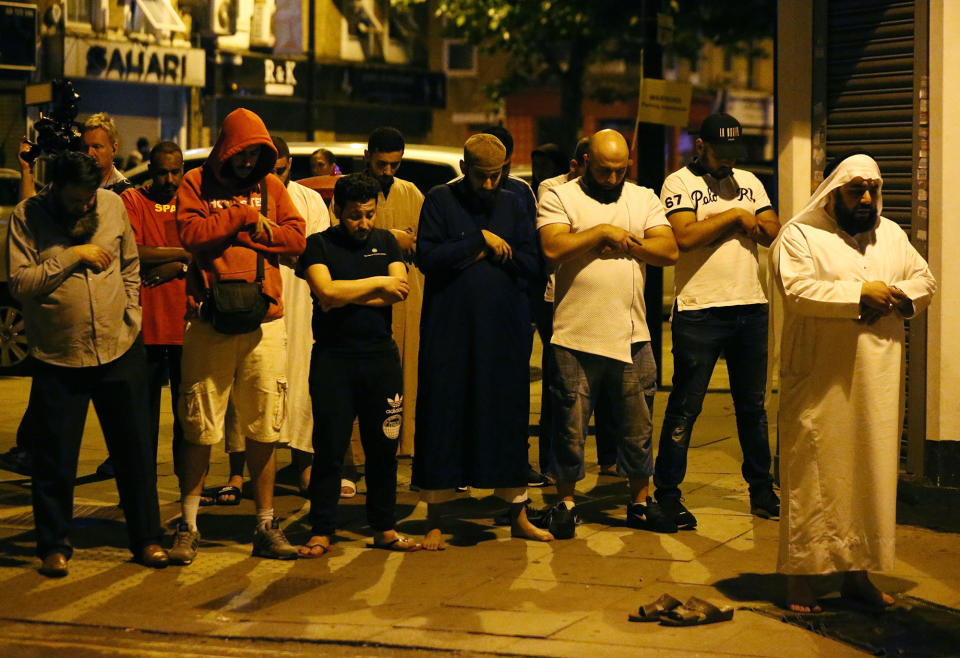 <p>JUN. 19, 2017 – Men pray after a vehicle collided with pedestrians near a mosque in the Finsbury Park neighborhood of North London, Britain. A van plowed into worshippers in the early hours of Monday, injuring 11 people, two of them seriously, in what Prime Minister Theresa May said was a sickening, terrorist attack on Muslims. (Photo: Neil Hall/Reuters) </p>