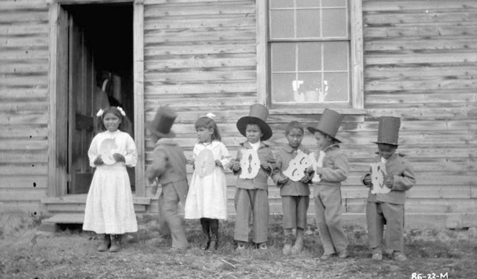 Children hold letters that spell 