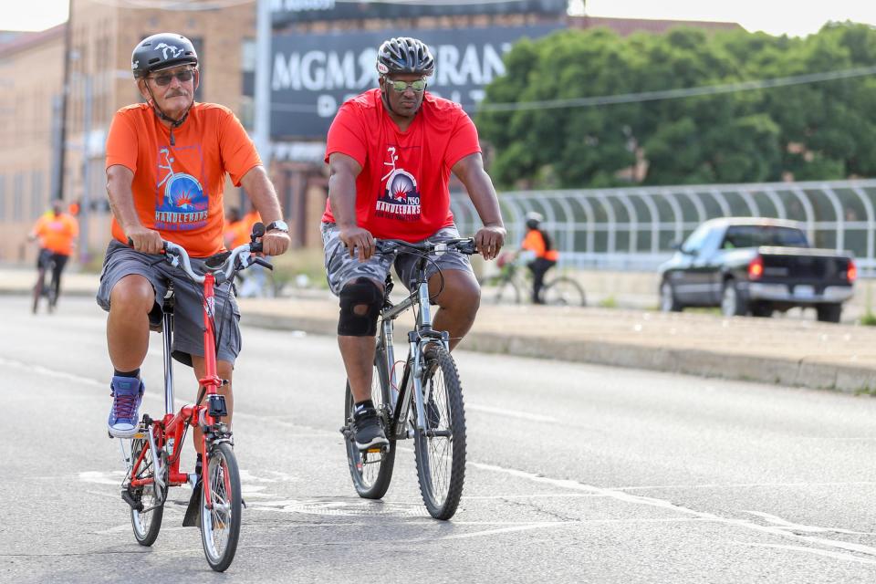 Thomas Page, of New Center in Detroit, and David Rudolph, 55, of Detroit, lead the practice ride for Neighborhood Service Organizaiton's Handlebars for the Homeless bicycle tour fundraiser in Detroit on Thursday, July 28, 2022. The event raises funds for homeless people in Detroit and is back in person with a new 15-mile route beginning and ending at the iconic NSO Bell Building.