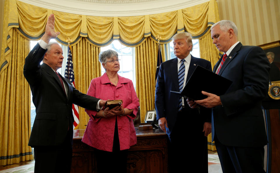 Trump watches as Vice President Mike Pence, right, swears in Jeff Sessions, left, as U.S. attorney general while his wife, Mary Sessions, holds the Bible in the Oval Office of the White House&nbsp;on Feb. 9, 2017.