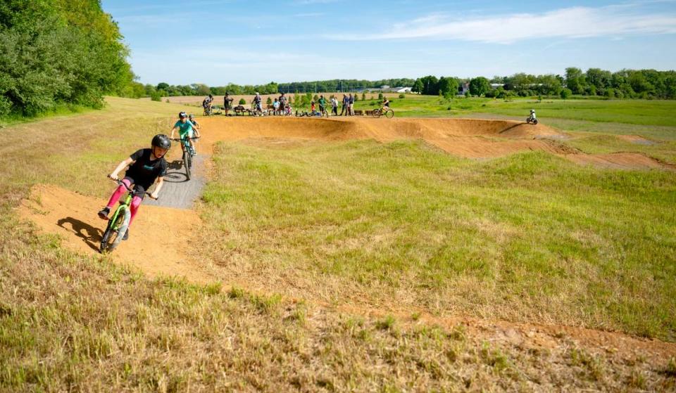 A group rides the new dirt pump track at Bernel Road Park on Tuesday, May 21, 2024.