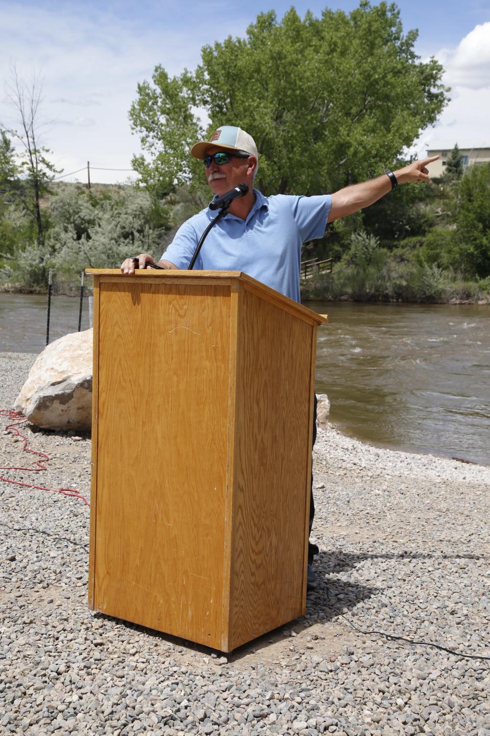 San Juan County Commission Chairman Steve Lanier gestures toward the pillars of the old Denver & Rio Grande Western Railroad tracks that remain standing at the site of a new boat ramp on the Animas River in Cedar Hill on Tuesday, June 6.