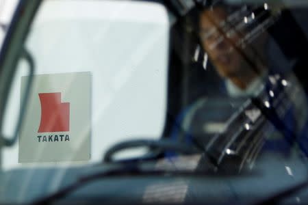 A logo of Takata Corp is seen through a car window outside the company's headquarter building in Tokyo in this April 12, 2013 file photo. REUTERS/Yuya Shino/Files