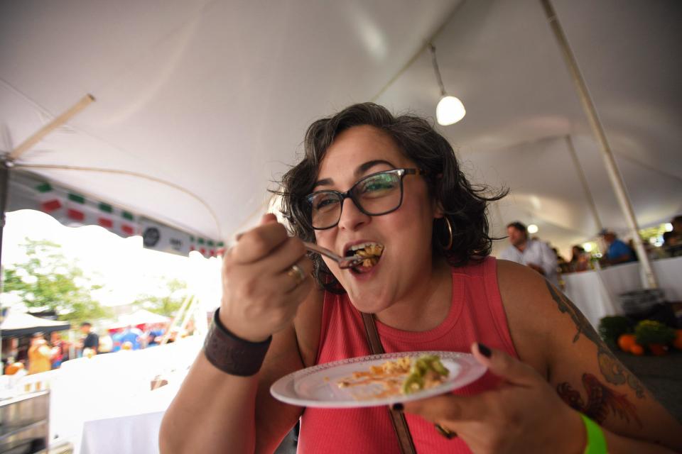 A woman who declined to give her name, takes a big bite during the Bergen County Food & Wine Festival 2021at Garden State Plaza in Paramus 09/12/21. 