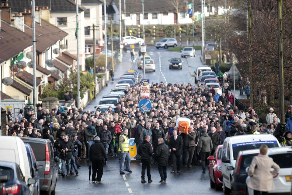 Friends and family carry the coffin of Martin McGuinness through the bogside area of Londonderry, Northern Ireland, Tuesday, March, 21, 2017. Martin McGuinness, the Irish Republican Army warlord who led his underground, paramilitary movement toward reconciliation with Britain, and was Northern Ireland's deputy first minister for a decade in a power-sharing government, has died, his Sinn Fein party announced Tuesday on Twitter. He was 66.(AP Photo/Peter Morrison)