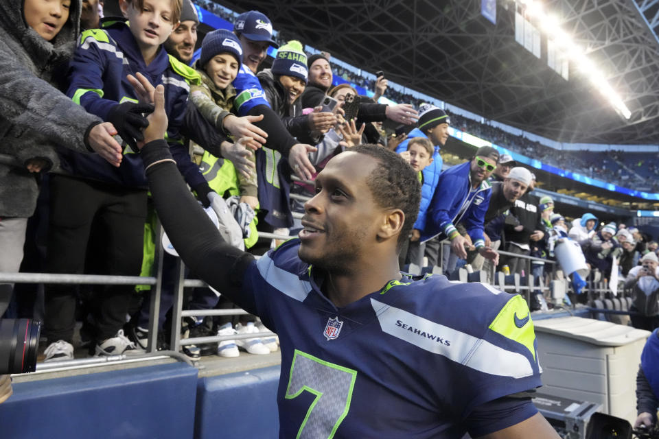 Seattle Seahawks quarterback Geno Smith (7) celebrates with fans after an NFL football game against the New York Jets , Sunday, Jan. 1, 2023, in Seattle. The Seahawks defeated the Jets 23-6. (AP Photo/Ted S. Warren)