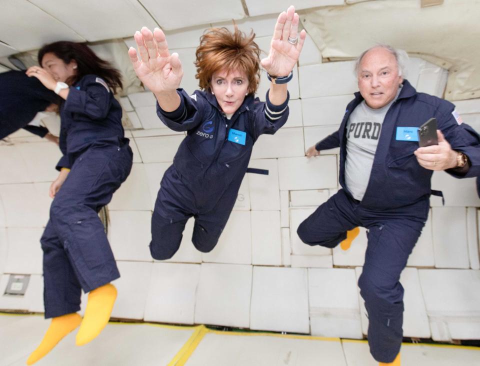 Sharon and Mark Hagle floating in zero gravity