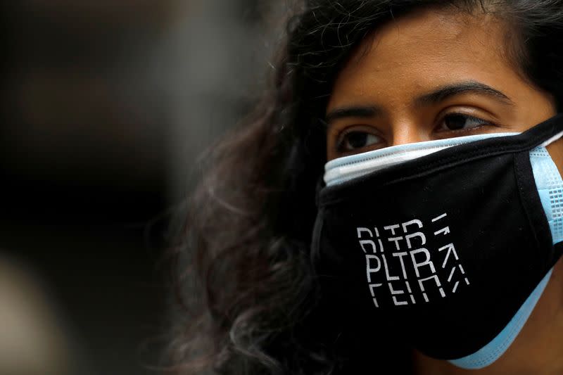 FILE PHOTO: A person wears a Palantir Technologies (PLTR) face mask at the New York Stock Exchange (NYSE) on the day of the company's initial public offering (IPO) in Manhattan, New York City