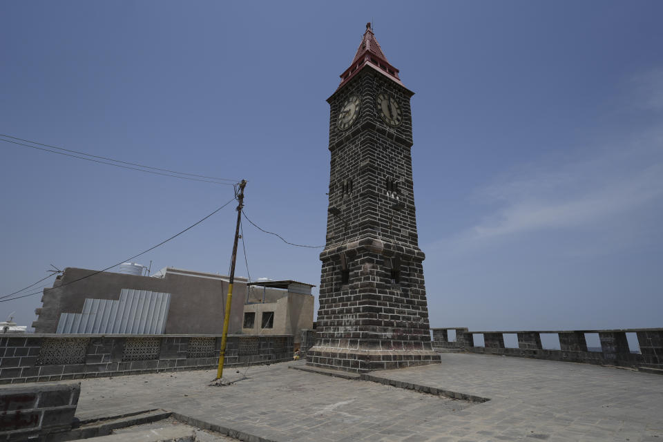 A clock made in a likeness to 'Big Ben' stands on a hilltop overlooking the city Aden, Yemen on Thursday, Sept. 15, 2022. Believed to have been built by British engineers in the late 19th century, it was built of local rock to resemble the famous London landmark. The death of Queen Elizabeth II has prompted some Yemenis to remember British colonial rule that oppressed many and deepened divisions inside the country. Since Aden gained independence in 1967, it has turned into the country's second capital amid a brutal years-long civil war. (AP Photo/Alaa Noman)