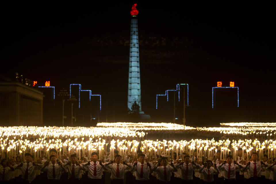 North Korean students take part in a torch light march held in conjunction with the 70th anniversary of North Korea's founding day celebrations in Pyongyang, North Korea, Monday, Sept. 10, 2018. (AP Photo/Ng Han Guan)